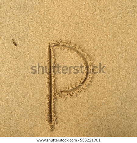Handwriting words "p" on sand of beach