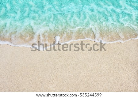 Soft beautiful ocean wave on sandy beach. Background. Royalty-Free Stock Photo #535244599