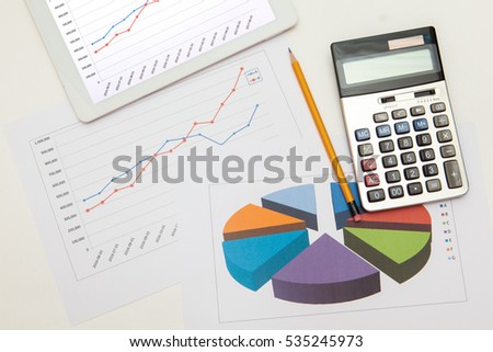 sales graph chart on paper, tablet, dollar, glasses and pencil on white backgrounds