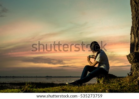 A photographer try to take a picture of season change in sunset with a smart phone . Royalty-Free Stock Photo #535273759