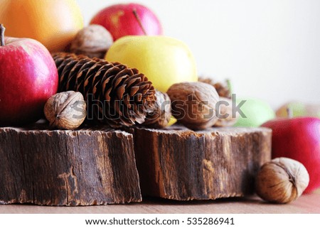 Fall background. Apples. Cones. Nuts. Wood texture.