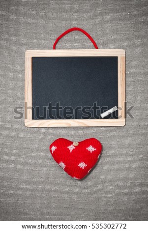 Beautiful Colored vintage Valentines creative card background. Free empty space on black board, free space around on linen fabric on table with shadow. Mock up.