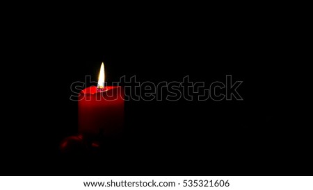 Red candle with yellow candle light