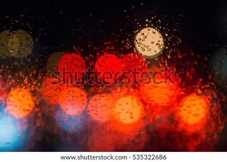 Rain drops on window with street bokeh lights.