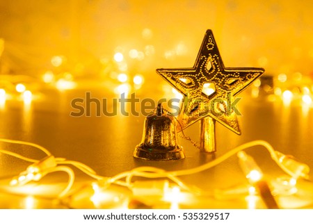 golden glittering christmas star and bell on Light Bokeh background