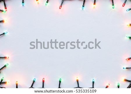 colorful glowing garland on white background Christmas frame mockup