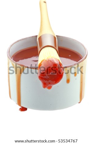 Barbecue sauce and basting brush isolated on white.