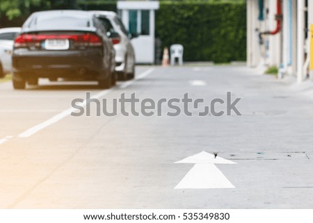 Road sign in car park and car driving background