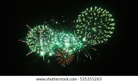 green Fireworks light up the sky with dazzling display celebration  New years eve congratulations event. stock, photo, photograph, picture, image