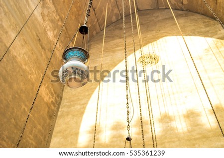 arabic Lamp At the mosque, And write the Arabic "alllah nur alssamawat wal'ard mathal nurih kamishka.."  Allah is the light of the heavens and the earth; a likeness of His light is as a niche..