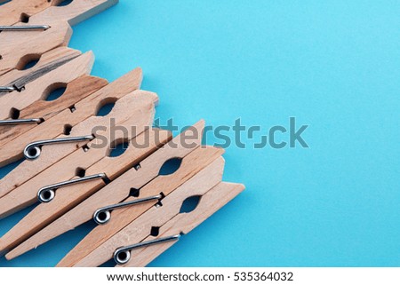 Wooden Pins on Blue Background.