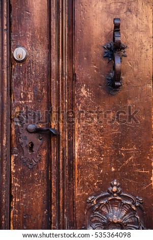 texture of old wooden door with iron handle and lock