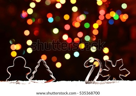 Silver Christmas Cookie cutters with colorful bokeh background