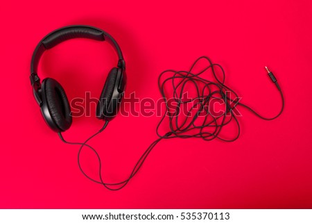 headphones on red surface