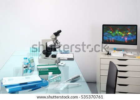 Microscopic work station. Microscope, computer monitor with digital fluorescent image and tools for histological staining of tissue to detect cancer and analyze patients tissue. 