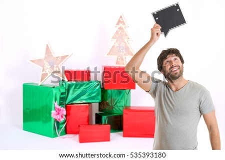 Portrait of a crazy man holding picture frame at christmas