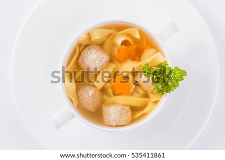 chicken broth on a light background (close top view)