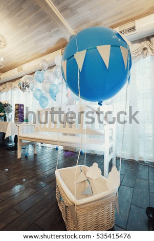 Decorative white bascket with blue balloon over it