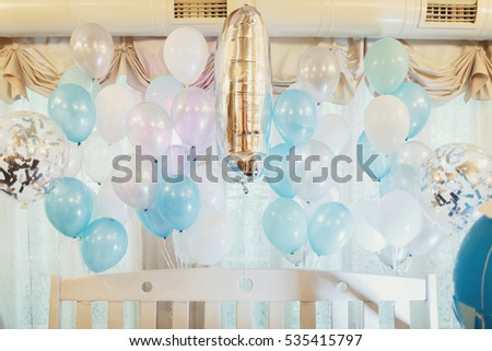 Blue balloons hang under ceiling