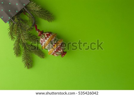 Christmas composition with fir tree branch and Xmas decoration on greenery background. Top view, flat lay. Copy space for text