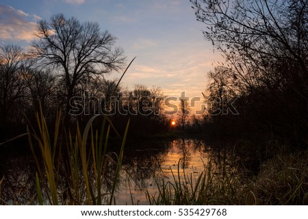 Late fall. The picture was taken in the early morning in late November. It was an interesting dawn. Beautiful landscape of the river is very calm and soothing, it is possible to watch indefinitely.