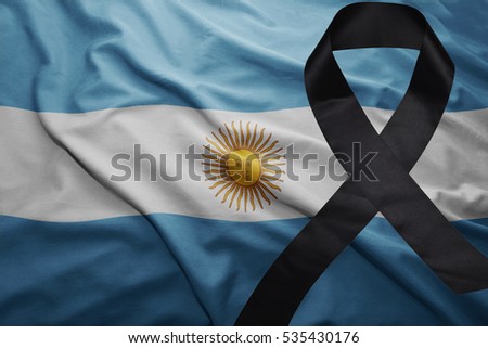 waving national flag of argentina with black mourning ribbon
