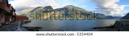 Panoramic view of Sogne Fjord Norway. On the picture there are mountains, kemping and a man with two dogs