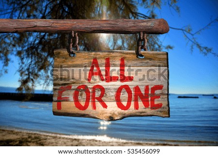All for one motivational phrase sign on old wood with blurred background