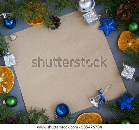 Greeting card on wooden background with Christmas decorations.