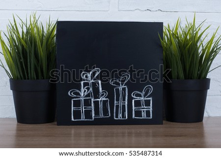 gift boxes on black chalkboard background.
