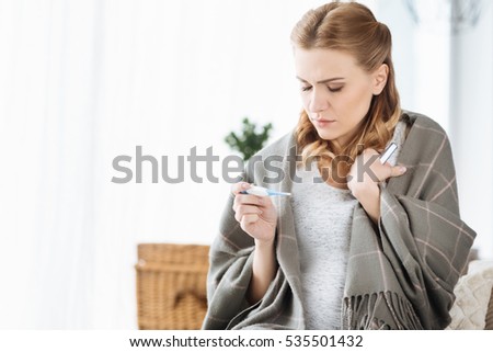 Pregnant woman holding thermometer Royalty-Free Stock Photo #535501432