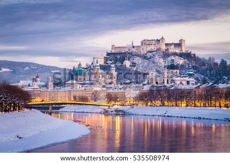 Classic view of the historic city of Salzburg with famous Festung Hohensalzburg and Salzach river illuminated in beautiful twilight during scenic Christmas time in winter, Salzburger Land, Austria Royalty-Free Stock Photo #535508974