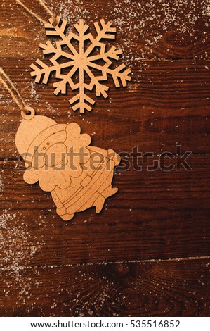 christmas natural wooden figures, santa claus, on a wooden boards background