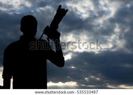 Silhouette Photographer holding a camera zoom range.