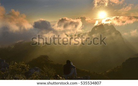 Sitting calm with gold sunset and mountain in an evening,Thailand