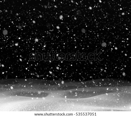Winter background. Winter landscape with falling snow and snowdrift on  black background