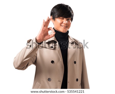 Asian handsome man making OK sign