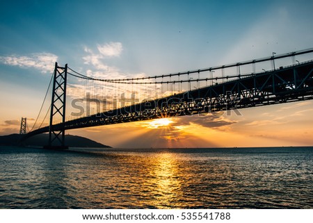 Bottom view of Bridge and Sunset at Akashi Kaikyo Bridge, suspension bridge, spanning the Seto Inland Sea from Awaji Island to Kobe, Japan