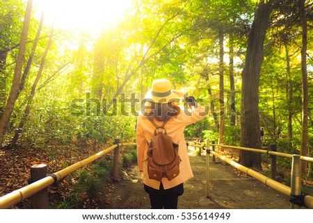 Woman is travel into nature park.