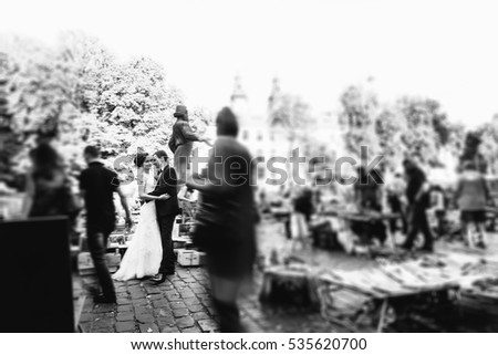Blurred picture of newlyweds standing in the crowd