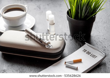 elimination of tobacco smoking electronic cigarette on dark background