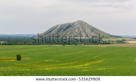 The view from the field on a single mountain Yuraktau Royalty-Free Stock Photo #535629808