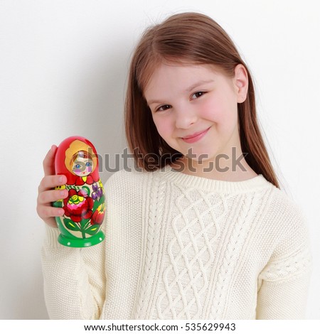 Beautiful russian teen girl holding matryoshka