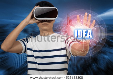 Young man with virtual glasses. Standing hand out to touch a button idea. The idea imagination.