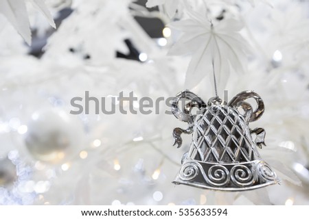 Christmas tree background with white artificial maple and silver bell and gift box