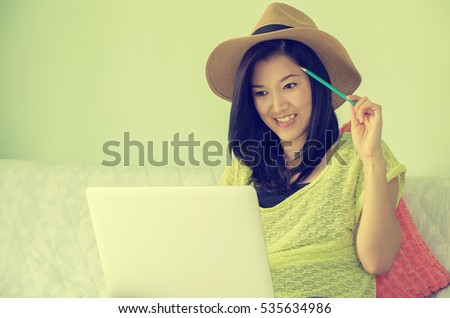 Happy young beautiful asian woman using laptop, Indoors. Vintage Style.
