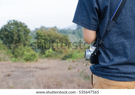 professional photographer with camera in forest. Vintage tone.