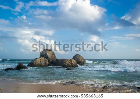 Stone rock in the ocean. Background. Sri Lanka. Indian Ocean Beach. Boulder.