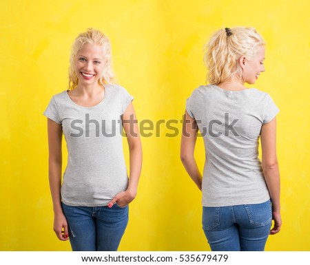 Woman in grey round neck T-shirt on yellow background