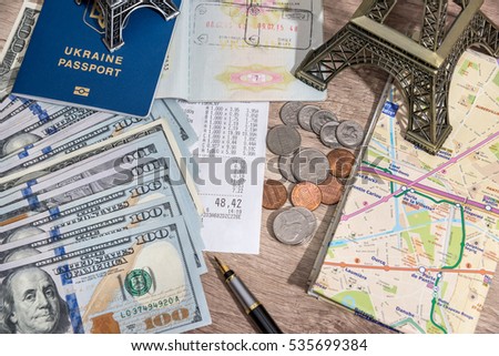 passport with US currency and map, toy eiffel tower, check for a background.
